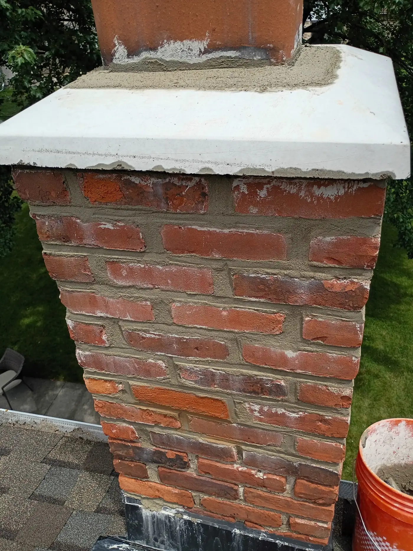 Worn, cracked chimney crown before repair